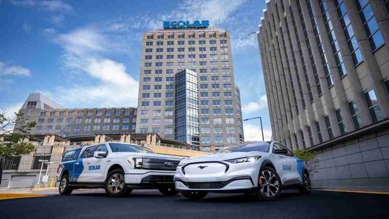 Parked near headquarters a pair of Ford vehicles waits to roll