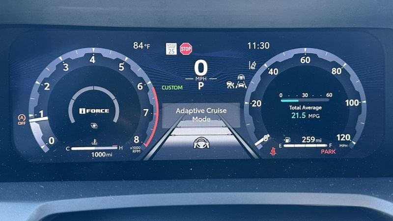 A Toyota Tacoma's dashboard displaying gauges and indicators. Speedometer reads 0 MPH. Adaptive Cruise Mode is active. Temperature shows 84°F. Time is 11:30. Odometer displays 1,000 miles.