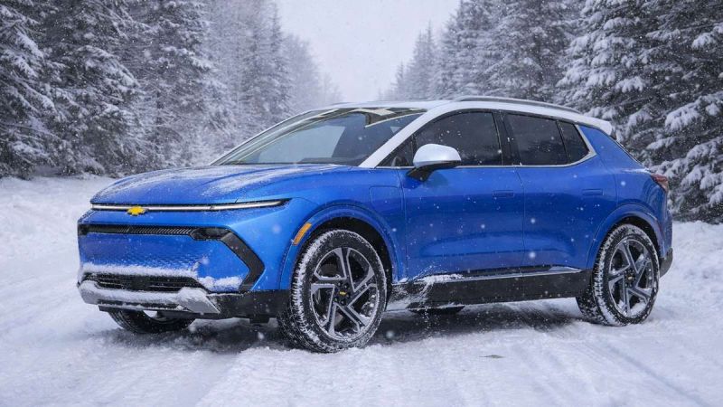 Blue 2025 Chevy Equinox EV on a cold winter road