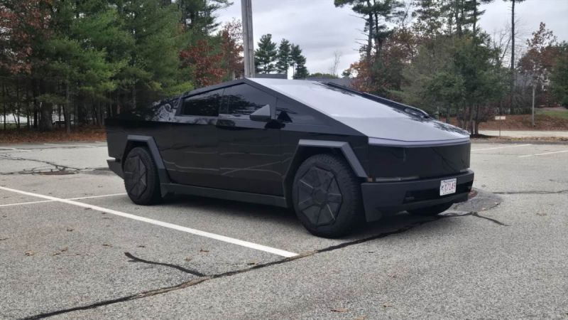 A Tesla Cybertruck looks menacing in a dark black glossy wrap