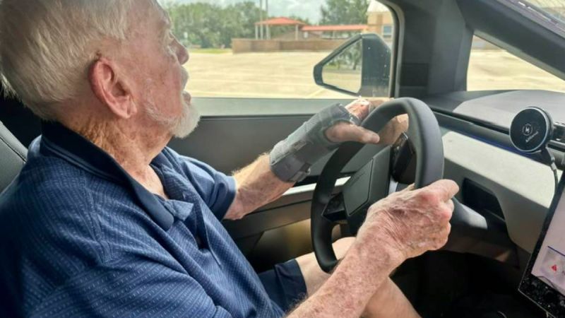Dennis gripping the steering wheel, focused on the road ahead in Tesla Cybertruck
