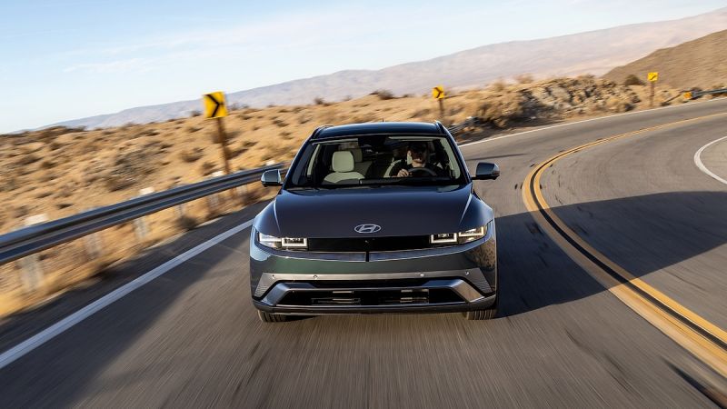 Hyundai Ioniq 5 electric SUV front three quarter view driving on desert highway