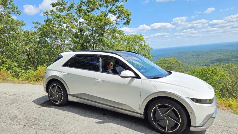 Image of white 2025 Hyundai Ioniq 5 Limited atop a mountain in New Hampshire with scenic Vista.