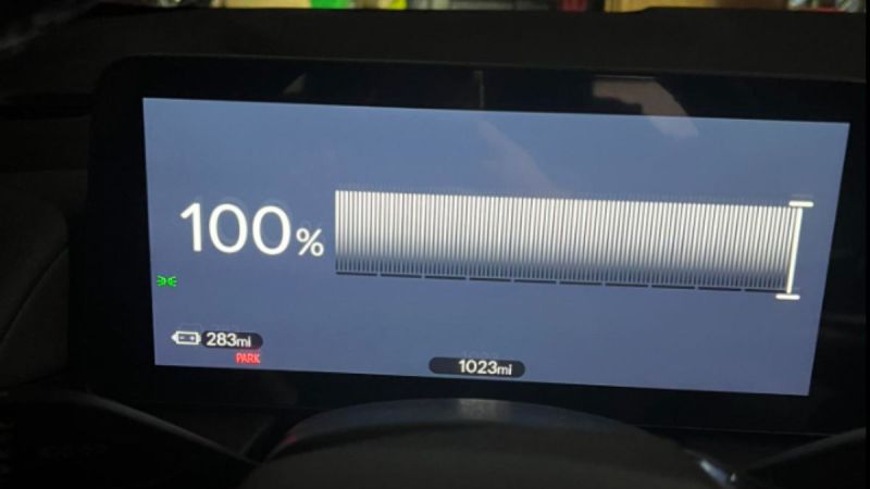 Marielle's Honda Prologue dashboard shows a full 100% charge, indicating a driving range of 283 miles. The odometer reads 1023 miles, with "Park" displayed.