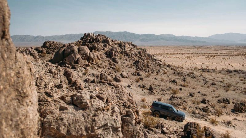Rivian R1S off road in high desert mountains