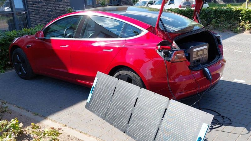 Red Tesla Model 3 with DIY solar power charger