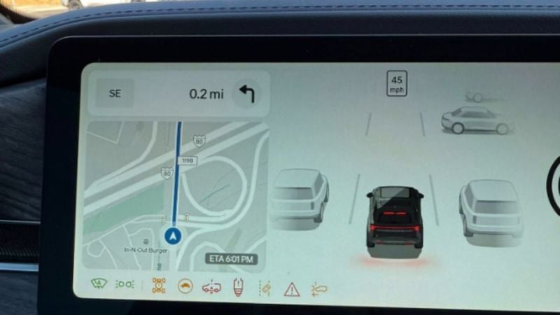 Car navigation screen showing map with 0.2 mile route, vehicle speed of 45 mph, and stylized car icons near In-N-Out Burger location