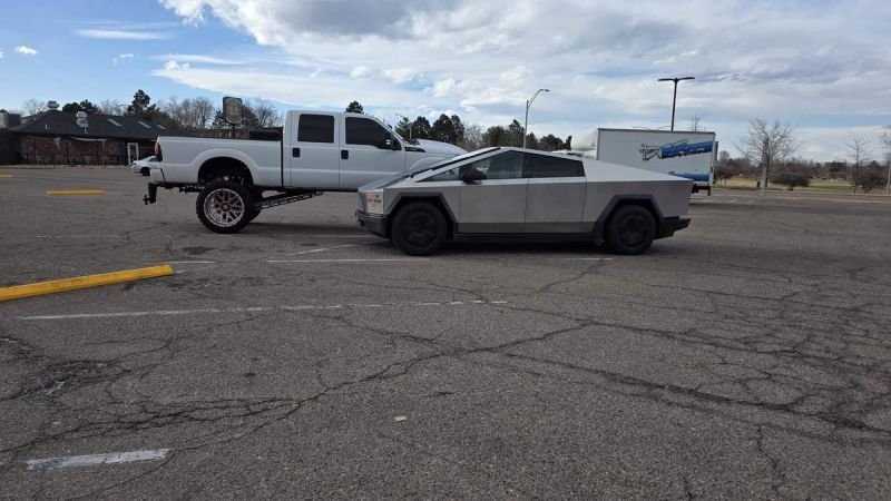 Tesla Cybertruck next to White Ford 
