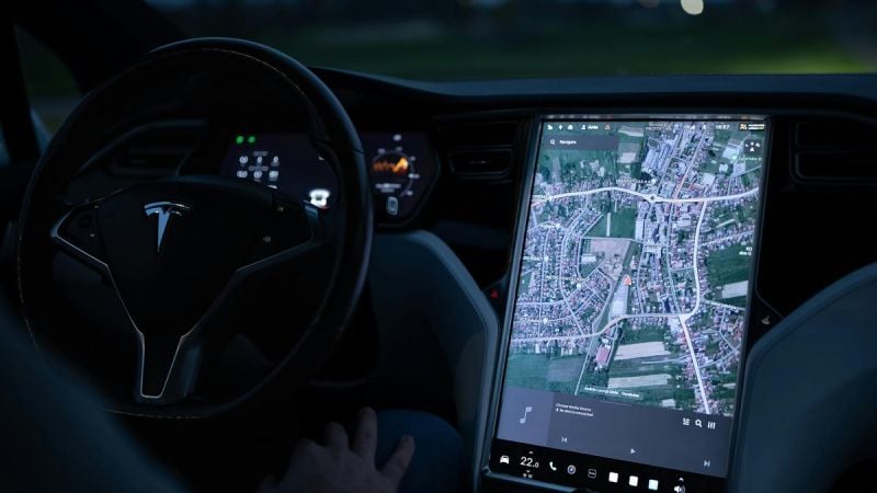 Tesla Model S interior with screen showing the map of a city in extreme detail