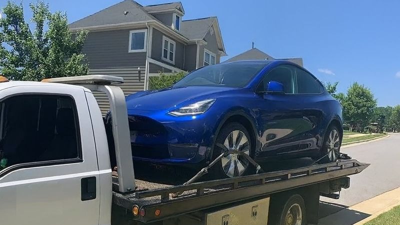 Tesla Model Y on the back of a flatbed towing truck