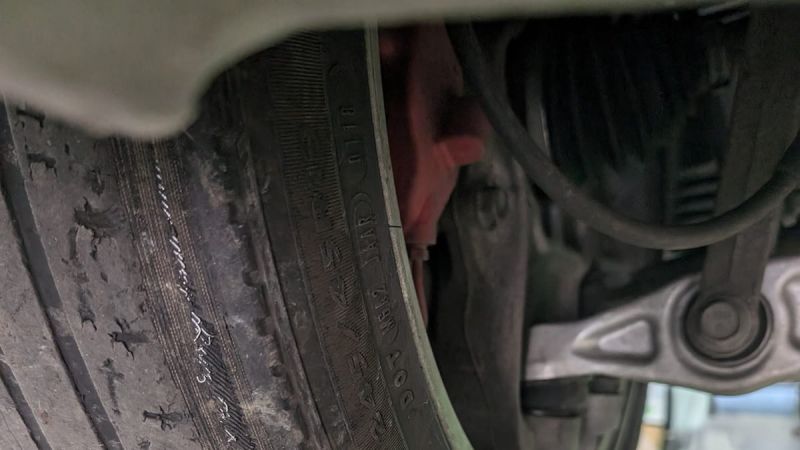 Picture of rear tire on a Tesla with excessive wear on the inside due to poor camber adjustment