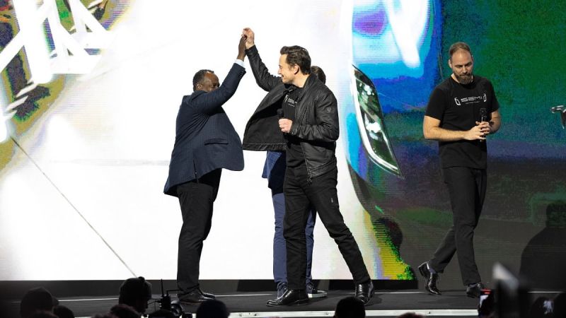 Tesla launch event showing Elon Musk on stage