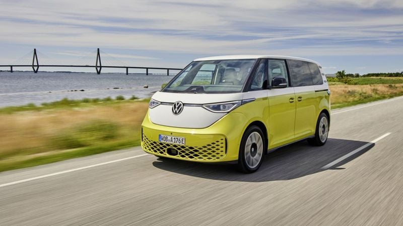 Yellow VW ID. Buzz cruising next to ocean