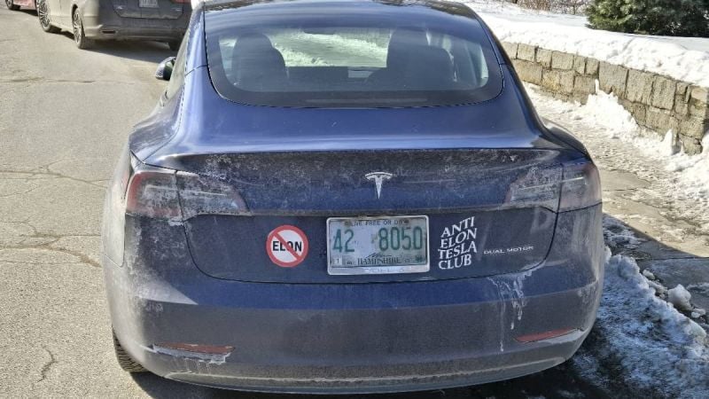 Image showing anti-Elon Musk bumper stickers on a Tesla Model Y