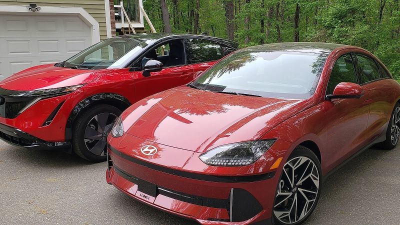 A Hyundai Ioniq 6 and Nissan Ariya sit side by side in brilliant red