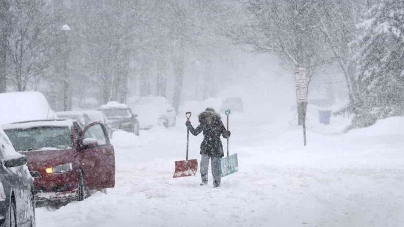 A Vehicle Owner Starts To Dig Out From A Blizzard