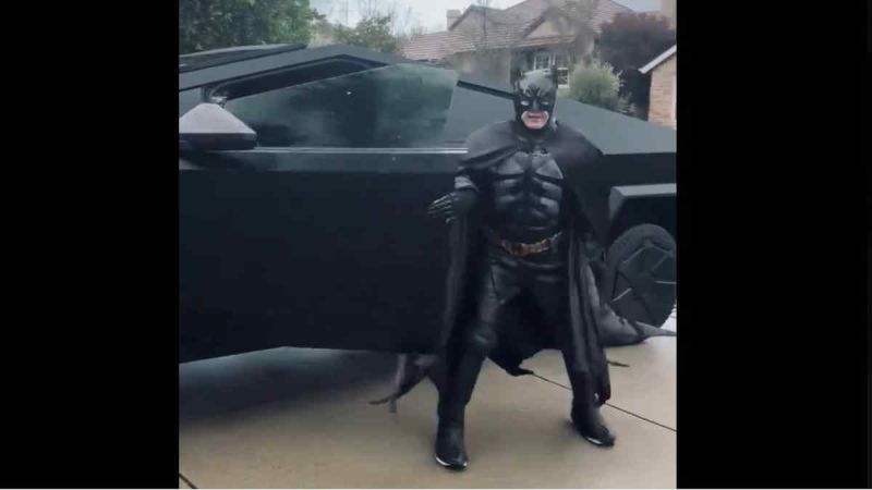 Cybertruck Owner Recreates Black Matte Wrapped "Batmobile" Cybertruck With Music And Costume To Boot