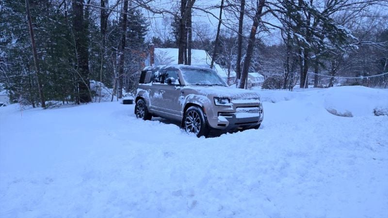 A 2026 Land Rover Defender 110 sits in a pile of snow