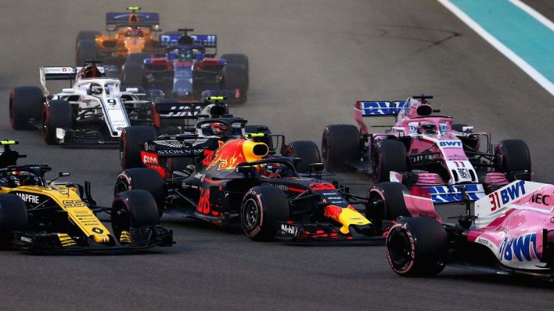 Image showing numerous F1 cars piling into a corner.