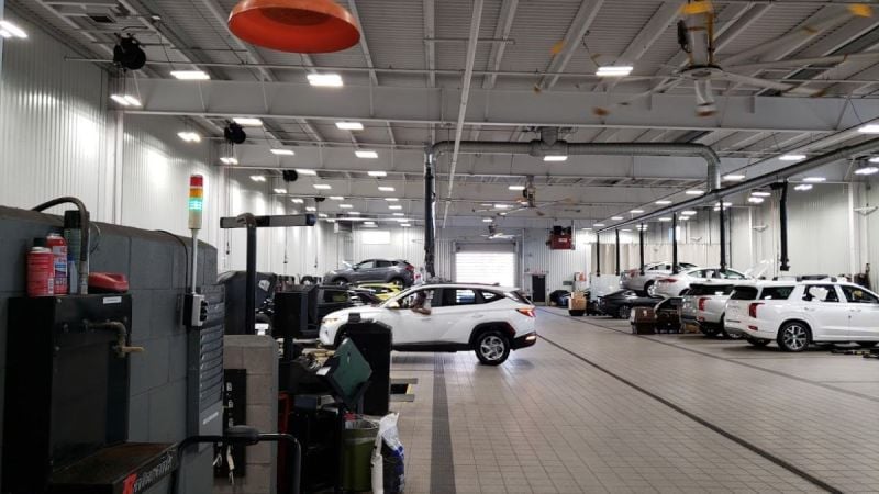 Image shows a Hyundai dealer service area performing repairs on various models