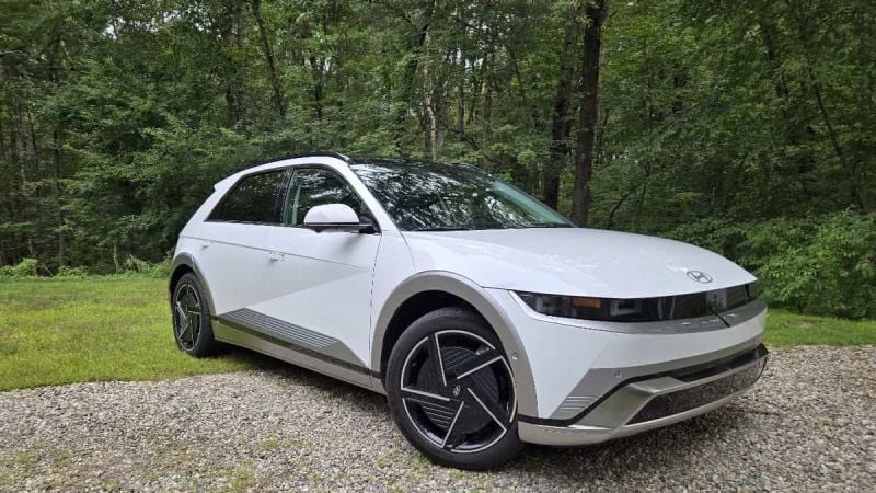 2025 Hyundai Ioniq 5 Limited in Atlas White shown with a wooded backgdrop 
