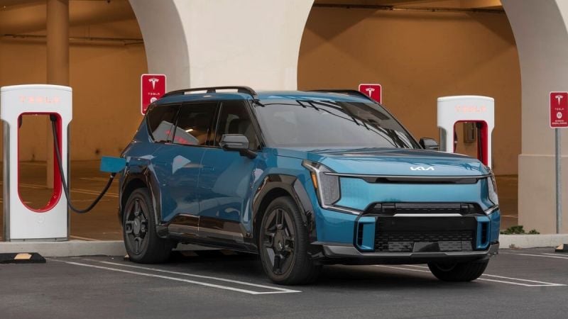 Image of a 2025 Kia EV charging up at a Tesla Supercharger courtesy of Kia media support. 