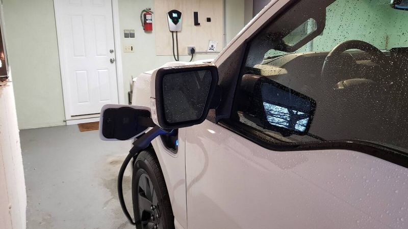 A Ford F-150 Lightning EV pickup charges inside an owner's garage