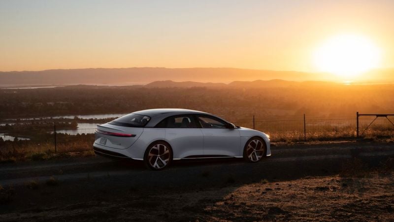 Image showing a white Lucid Air parked overlooking a valley at sunset