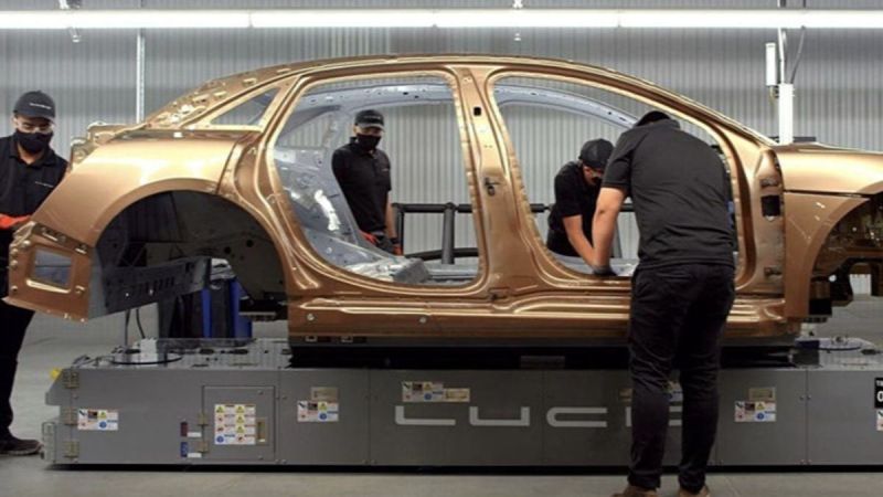 Image showing technicians assembling a Eureka gold Lucid Air at the company's AMP-1 production facility in Casa Grande, Arizona