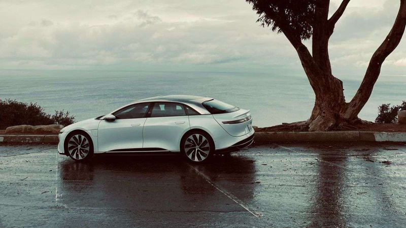 Image showing a white Lucid Air parked in the hills of California on an overcast and rainy winter's day.
