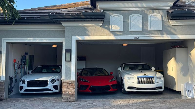 Luxury garage showing Bentley, Chevrolet Corvette, and Rolls Royce parked inside
