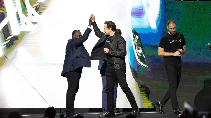 Image of Elon Musk giving high five courtesy of Tesla, Inc.