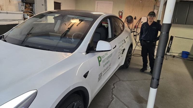 Image shows pest control owner with his 2025 Tesla Model Y Performance work vehicle