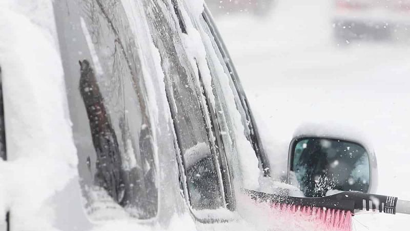 Snow-covered car cleaned in polar vortex time.