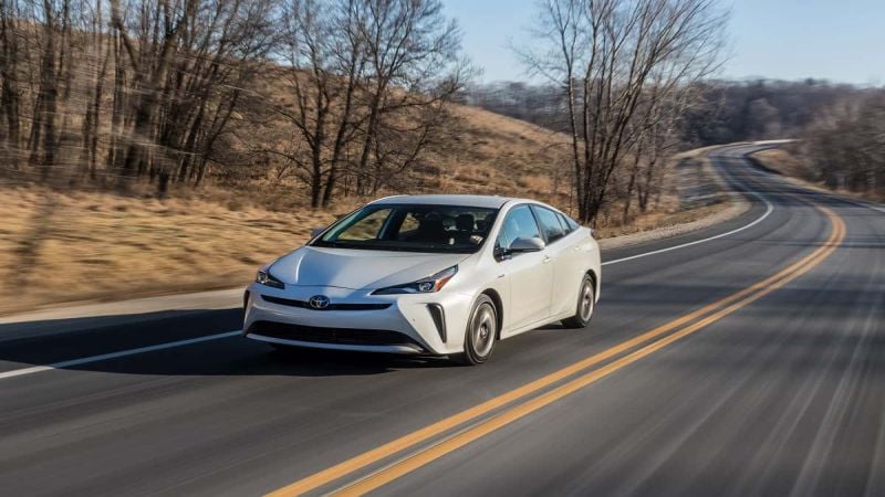 Prius beats which car in a race?