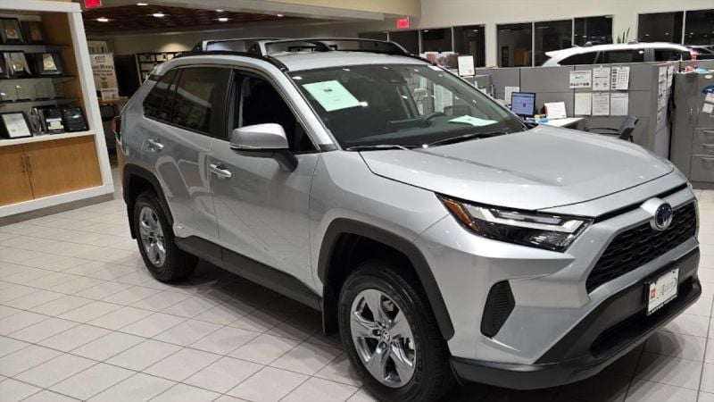 A Toyota RAV4 Hybrid awaits a buyer at a Toyota dealership