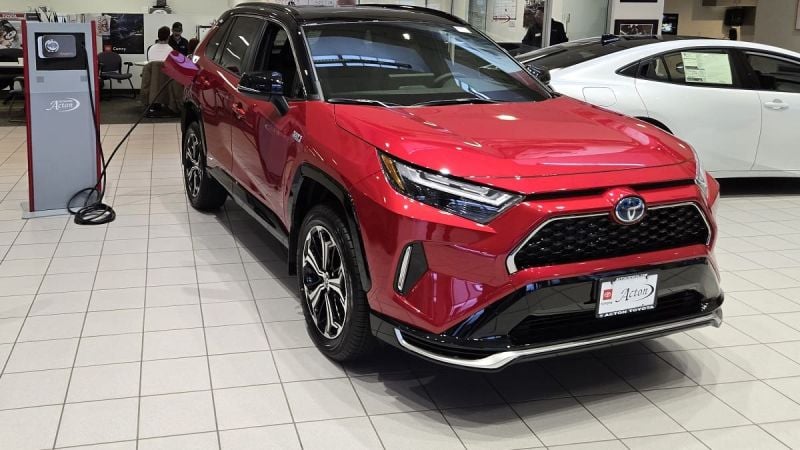 A Toyota RAV4 Plug-In is shown on display in a dealer showroom