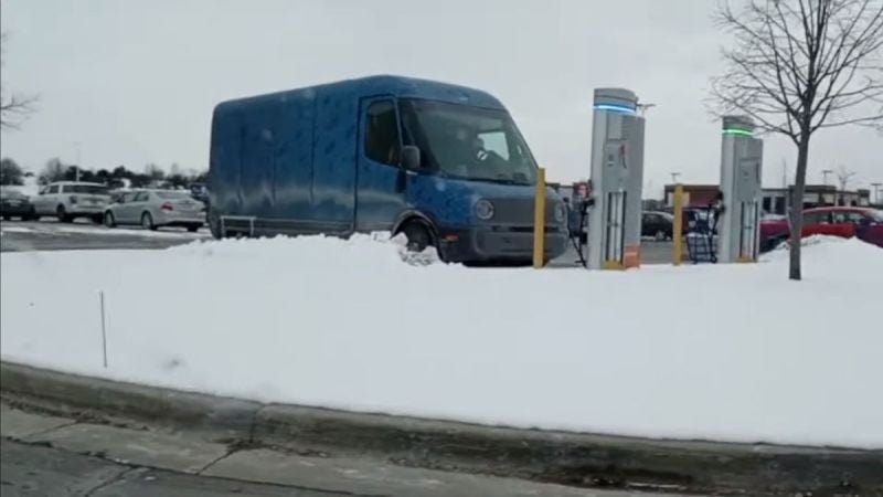 Image captured from a YouTube video showing a prototype Rivian EDV charging in a parking lot.