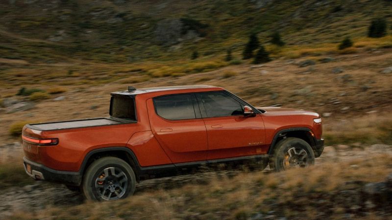 Red Rivian R1T electric pickup driving off road