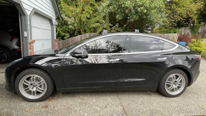 Black Tesla model 3 with silver mag wheels