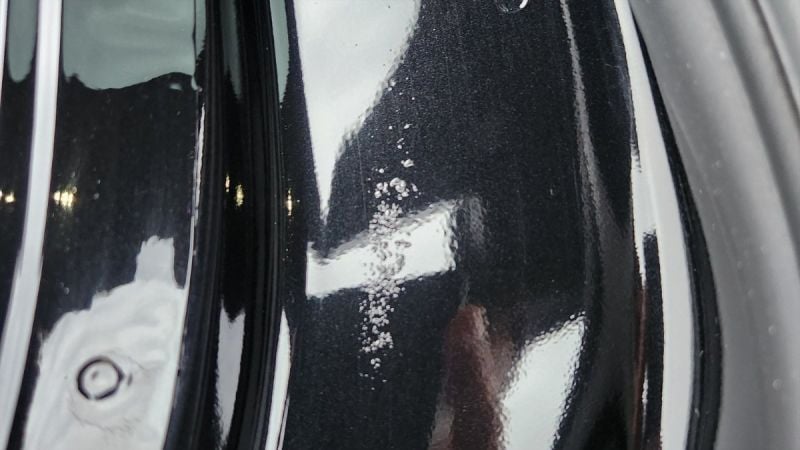 A Tesla Model Y with a paint defect is shown