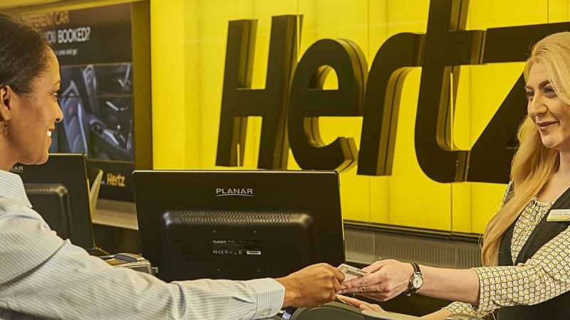 A customer talks to a Hertz sales associate