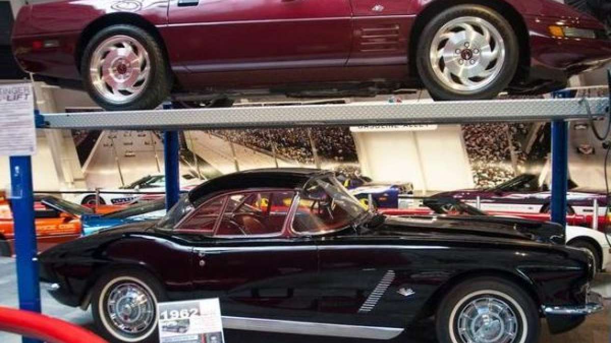 two corvettes on a lift