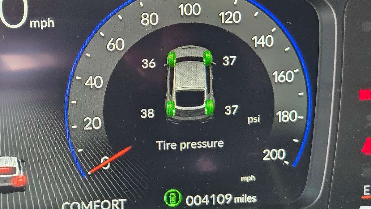 An in-dash vehicle tire pressure display shows that tires are overinflated.