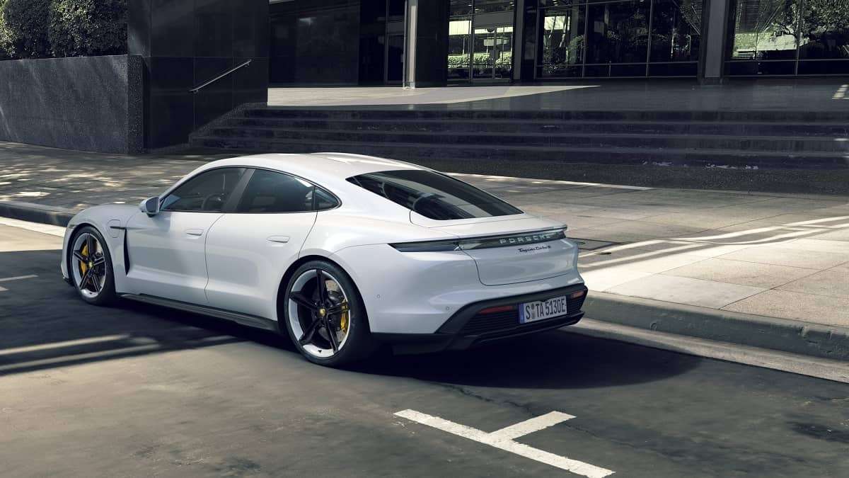 White Porsche Taycan rear side view on a street