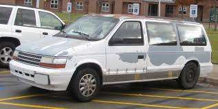 1990 beat up white dodge caravan 