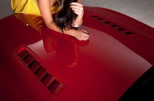 Dalena Henriques on the hood of the 2013 Ford Mustang GT
