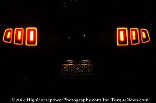 The 2013 Ford Mustang GT Premium Coupe from the rear in the dark