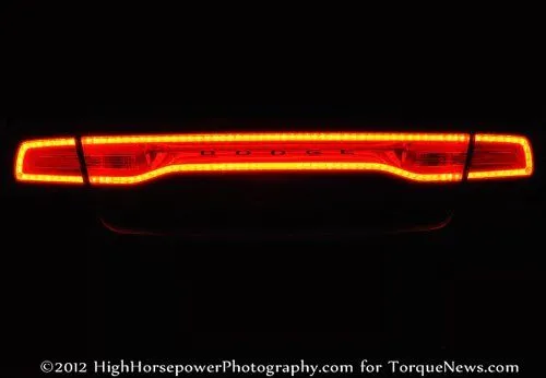 The taillight of the 2012 Dodge Charger SRT8 lit up at night.