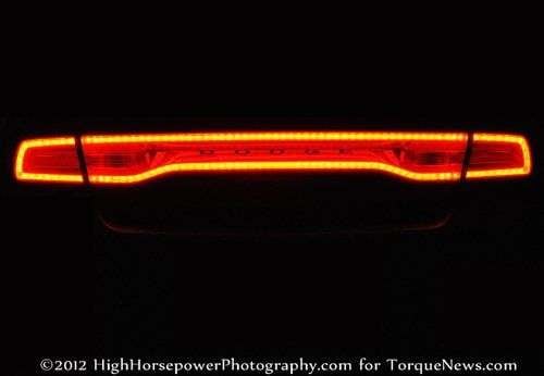 The taillight of the 2012 Dodge Charger SRT8 lit up at night.